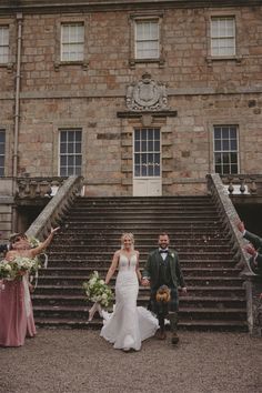 the bride and groom are walking down the stairs