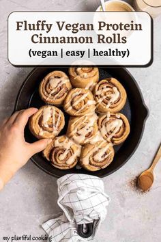 a pan filled with cinnamon rolls on top of a table