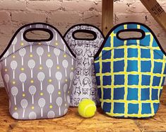 three bags with tennis balls and rackets on them