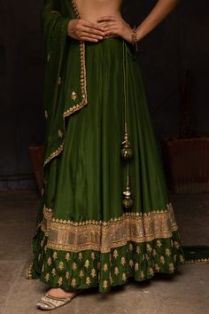 Leaf green silk lehenga in floral gota work. Paired with embroidered choli and dupatta.
Component: 3
Pattern: Hand embroidered
Type Of Work: Gota work, Sequins, Bead work
Neckline: V neck
Sleeve Type: Short sleeves
Fabric: Silk, Georgette
Color: Green
Other Details: 
Embroidered dupatta
Side tie up lehenga
Occasion: Mehendi, Haldi - Aza Fashions Green Lehenga With Pallu In Silk, Green Silk Lehenga With Pallu Detail, Green Silk Lehenga With Pallu, Green Lehenga With Cutdana And Kundan, Green Anarkali Lehenga With Resham Embroidery, Anarkali Style Green Lehenga With Resham Embroidery, Green Dola Silk Sharara For Reception, Green Anarkali Silk Choli, Green Silk Sets For Reception