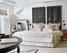 a bedroom with zebra rugs and white bedding