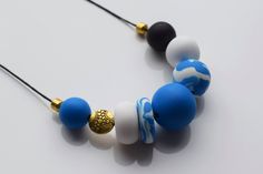 This handmade deep blue beaded necklace is made of unbreakable polymer clay beads. These beads are carefully made by hand, thus each of them can slightly differ in shape and smoothness. Each polymer clay necklace comes in a stylish packaging and makes a perfect gift. This modern necklace would be perfect for everyday wear or special occasion. You can easily dress in your own style with this blue necklace. Add some minimal, clean look to your outfit with this matte necklace. MORE DETAILS - Polyme Blue Beaded Necklace With Colorful Beads For Everyday, Everyday Blue Beaded Necklaces With Colorful Beads, Everyday Blue Beaded Necklace With Colorful Beads, Blue Necklaces With Wooden Beads For Gift, Minimalist Blue Round Bead Necklace, Blue Wooden Beads Necklace As Gift, Blue Wooden Beads Necklace For Gift, Colorful Beaded Polymer Clay Necklace As Gift, Blue Pendant Necklace With Large Beads