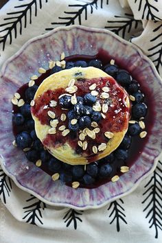 a plate with blueberries and pancakes on it