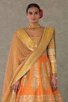 Rust raw silk lehenga with separate cancan skirt and dori, sitara kaam embellished with embroidered border and edged with kinari in son chidiya motifs. Paired with scoop neck embroidered padded blouse with patchwork digital printed sleeves and embroidered contrast borders. Comes with beige wallflower digital print dupatta with embroidered borders.
Components: 4
Pattern: Embellished, Embroidery, Printed
Type Of Work: Dori, sitara, wallflower
Neckline: Scoop neck
Sleeve Type: Full sleeves
Fabric: Embroidered Orange Traditional Wear For Reception, Orange Raw Silk Choli With Resham Embroidery, Orange Raw Silk Choli With Zari Work, Traditional Orange Sets For Reception, Orange Raw Silk Choli With Dupatta, Navratri Silk Thread Lehenga With Gota Work, Navratri Silk Lehenga With Gota Work, Transitional Raw Silk Choli With Cutdana, Fitted Silk Thread Sharara With Traditional Drape