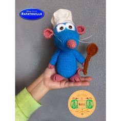 a crocheted mouse with a chef's hat holding a spoon in its hand