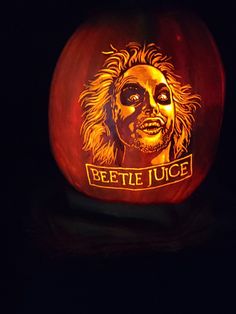 a carved pumpkin with the image of beetle lee on it's face and words beetife juice