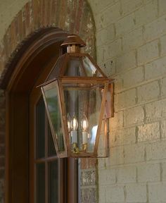 a light hanging from the side of a brick building