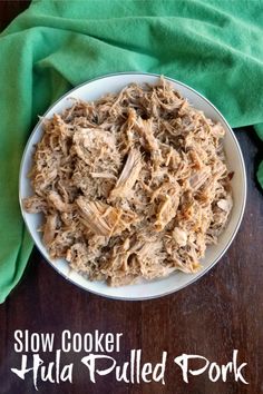 slow cooker tuna pulled pork on a white plate with green napkin and fork next to it