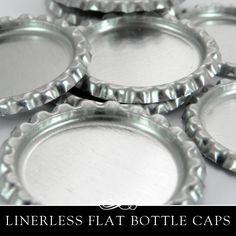 six metal bottle caps sitting on top of a white tablecloth with the words linerless flat bottle caps