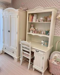 a white desk and hutch in a room with pink flowers on the wall behind it