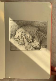 an open book with a drawing of a person sleeping