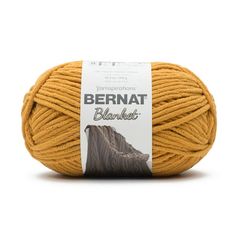 bernat blanket yarn in mustard yellow, on a white background with the label above it