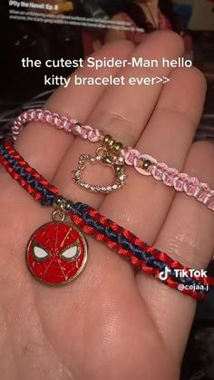 two bracelets with spider - man charms on them, one is red and the other is blue