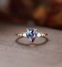 "MADE TO ORDER * Material: Solid gold(14K/18K white/yellow/rose gold) * DETAILS 57570 Engagement ring - Center stone: Lab Alexandrite 6*8 pear cut Side stone: Moissanite or Diamond - diamond:0.16ct,2*3mm pear cut, Color G-H, Clarity SI-VS - moissanite:0.16ct * Click on the \"Pin It\" icon if you like this item * Custom Order We can make custom rings in almost any shape and style. If you want a specific model, please send us a clear picture and we will do our best.  * Shipping Most items take 2-3 weeks to create. I'm happy to rush your order, fees may apply, write me for details. * Payment Plans I offer payment plans. The minimum per payment will be $100. Write me your finger size, metal color, How much you would like to pay for the first payment. I will create a payment plan which will be Color Changing Ring, Vintage Cluster Ring, Diamond Ring Vintage, Green Sapphire Engagement Ring, Cute Engagement Rings, Pear Ring, Alexandrite Engagement Ring, Alexandrite Ring, Pear Engagement Ring