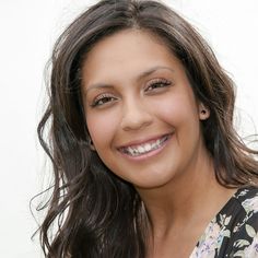 a close up of a woman smiling for the camera