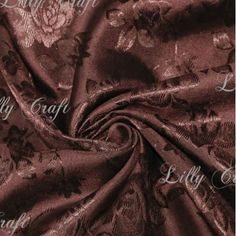 a close up image of a brown fabric with floral designs on the front and back