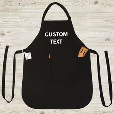 an apron with the words grandma written on it and a wooden spatula in front