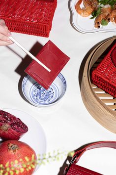 a table topped with plates and bowls filled with food next to utensils on top of a white table cloth