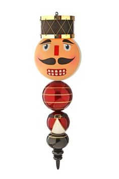 a glass ornament with an orange face and mustache on it's head