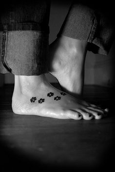 black and white photo of feet with paw prints on them