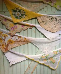 there are many different types of cloths hanging on the clothes line with doily