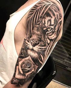 a man with a tiger and rose tattoo on his arm