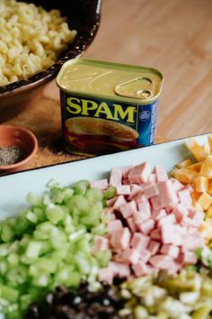 ingredients for spam sit on a cutting board next to a can of spam