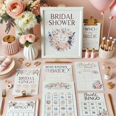 the bridal shower table is set up with pink flowers and gold accessories, including a sign