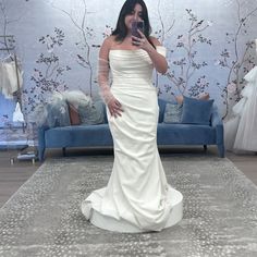 a woman is taking a selfie in her wedding dress