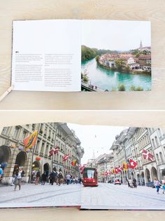 an open book on a wooden table with people walking in the street and a river running through it