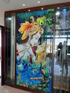 a painting on the side of a glass door in a building with peacocks around it