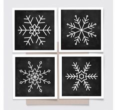 four snowflakes are shown on black paper