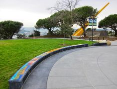 an empty park with green grass and trees