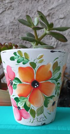 a potted plant with flowers painted on it