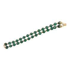 This is part of Chairish’s Costume Jewelry assortment.  Goldtone two strand cut green glass beads with round goldtone smaller spacer beads and filigree details near the fold over clasp. Marked "Napier." Measures: 7 5/8 inches long by 3/4 inches wide. Excellent condition. An identical bracelet except with red glass beads is shown on pg. 370 of Melinda L. Lewis & Henry Swen's book "The Napier Co.: Defining 20th Century American Costume Jewelry." Dates to 1963. Elegant Green Beaded Bracelets For Festive Occasions, Formal Beaded Bracelets, Green Multi-strand Beaded Jewelry, Green Multi-strand Beaded Bracelets With Faceted Beads, Green Vintage Glass Beaded Necklaces, Vintage Hand-strung Green Beaded Necklaces, Vintage Green Multi-strand Beaded Necklace, Glass Beaded Bracelets, Red Glass