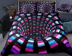 a bed with a colorful comforter and pillows