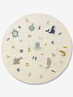 a white plate with various animals and letters on it's side, in the shape of a circle