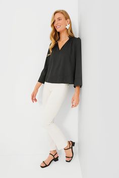 Effortlessly elevated, the Black Phillipa Blouse is a feminine silhouette that can be styled for countless occasions. This top drapes off the body in the most flattering way and features a stand collar with a gathered neckline, bracelet length sleeves, and a lightweight fabric that feels soft to the touch. Opt for light denim and sandals for a glamorous brunch look and swap for trousers and flats for a day in the office. Stand collar V-neckline Gathering on neckline and back Wide sleeves Bracele Stretch Split Neck Blouse, Chic Stretch Blouse For Work, Chic Stretch Blouse For Business Casual, Spring Stretch Blouse For Business Casual, Chic Solid Color Split Neck Tops, Stretch Blouse With Gathered Sleeves, Chic Solid Color Split Neck Blouse, Chic Solid Split Neck Blouse, Feminine Stretch Blouse For Fall