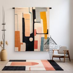 an abstract painting hangs on the wall next to a chair