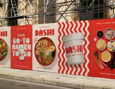 a red and white advertisement for ramen to go on the side of a building