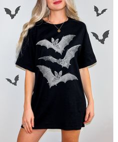 Embrace the spooky season with our Vintage Halloween Bat T-Shirt! This retro-inspired tee features a classic bat graphic that is perfect for Halloween and beyond. Whether you're a fan of gothic fashion or just love unique vintage designs, this t-shirt is a must-have addition to your fall wardrobe. ♥ COLOR: White, Natural, Heather Navy, Heather Dark Grey, Black ♥ PRODUCTION TIME: 1-5 days (Usually 2-3 days) ♥ SHIPPING TIME: 2-5 days (Usually 3 days) ♥ PRODUCT DESCRIPTION: Bella Canvas Unisex T-sh Gothic Black T-shirt For Halloween, Spooky Black T-shirt For Fall, Spooky Black T-shirt With Skull Print, Halloween Black T-shirt With Character Print, Black Gothic T-shirt For Fall, Spooky Halloween T-shirt With Graphic Print, Black Spooky Crew Neck Top, Witchy Black Top For Costume Party, Black Witchy Tops For Costume Party