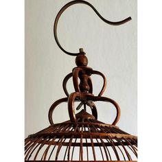 a bird cage with a figurine hanging from it's side and the top section