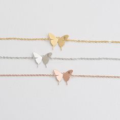 "These personalized butterfly bracelets will be perfect thank you gifts for your wedding, anniversaries, and birthdays. You can also gift these to your best friends, bridesmaids and sorority sisters! Great minimal bracelets for layering or for easy, everyday wear. D E T A I L S - Delicate Initial Butterfly charm - Butterfly Size: 13mm x 17 mm - Hand-Stamped Initial of your choice - We can stamp Uppercase letters, numbers,♡ (heart) - Available in Gold, Rhodium, or Rose gold Plated - This listing Stainless Steel Butterfly Necklace Gift, Butterfly Shaped Stainless Steel Jewelry For Gifts, White Butterfly Charm Bracelet For Gift, White Butterfly Bracelet For Gift, Dainty Butterfly Charm Bracelets For Gift, Dainty Butterfly Charm Bracelets As Gifts, Butterfly Charm Bracelet Jewelry Gift, Adjustable Butterfly Charm Jewelry For Wedding, Dainty Butterfly Charm Bracelet Gift