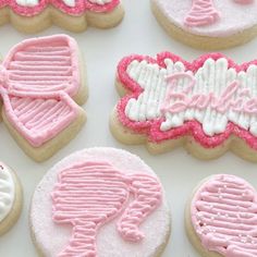 decorated cookies with pink and white icing on a table