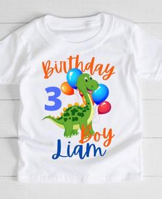 a white birthday shirt with an image of a dinosaur holding balloons and the number 3 on it