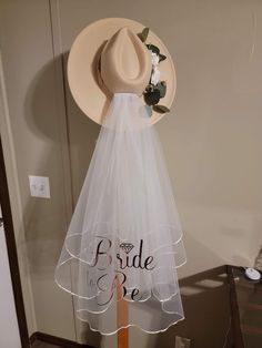 a hat and veil on display in a room