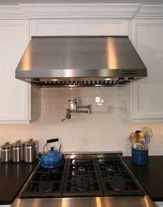 a stove top oven sitting inside of a kitchen