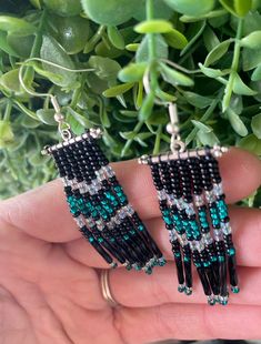 These 2.75 inch drop length fringe earrings exhibit an eye catching color combination of sheer turquoise (light and dark) and black. This pair combines two different shades of turquoise placed against a grounding, black background, creating a sharp and stunning look. They are complete with a silver colored bar finding and sterling silver, hypoallergenic ear wires.        $22.00 Drop length: 2.75  in Width: 0.75 in Approx. earring weight: 0.07 oz Toho and Czech Seed Beads Sterling Silver hypoalle Black Dangle Jewelry With Beaded Fringe, Black Fringe Dangle Jewelry, Black Dangle Jewelry With Fringe, Black Beaded Fringe Dangle Tassel Earrings, Black Beaded Fringe Tassel Dangle Earrings, Black Beaded Fringe Tassel Drop Earrings, Black Fringe Dangle Earrings, Black Fringe Drop Earrings, Beadwork Ideas