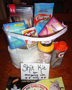 a basket filled with snacks and candy on top of a wooden table next to a sign