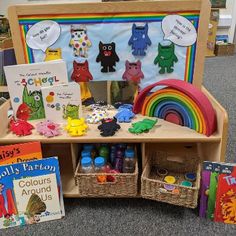 children's books and crafts are on display in a classroom setting with rainbows